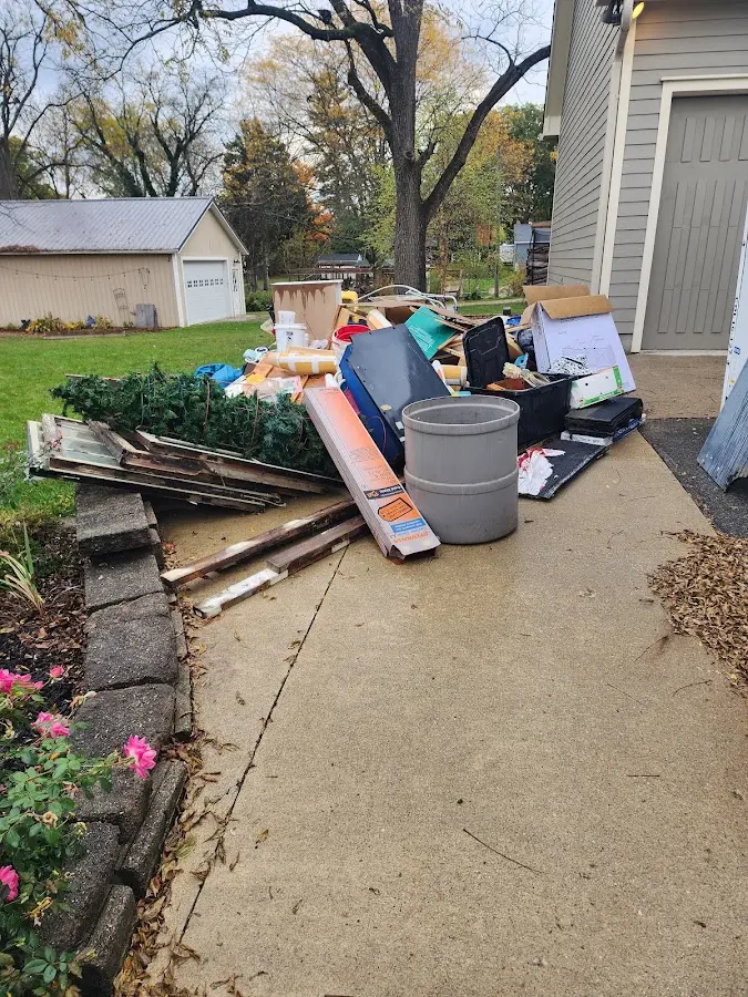 Dumpster being loaded with debris for Residential Dumpster Rental in Osceola